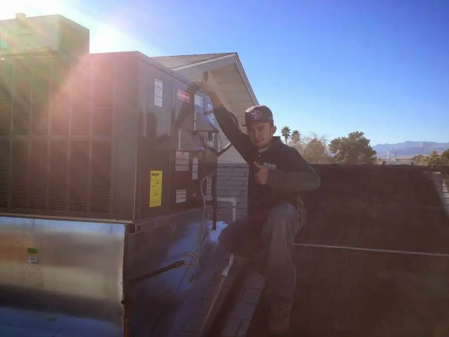 HVAC technician performing HVAC Inspection on a rooftop unit in Baltimore Highlands